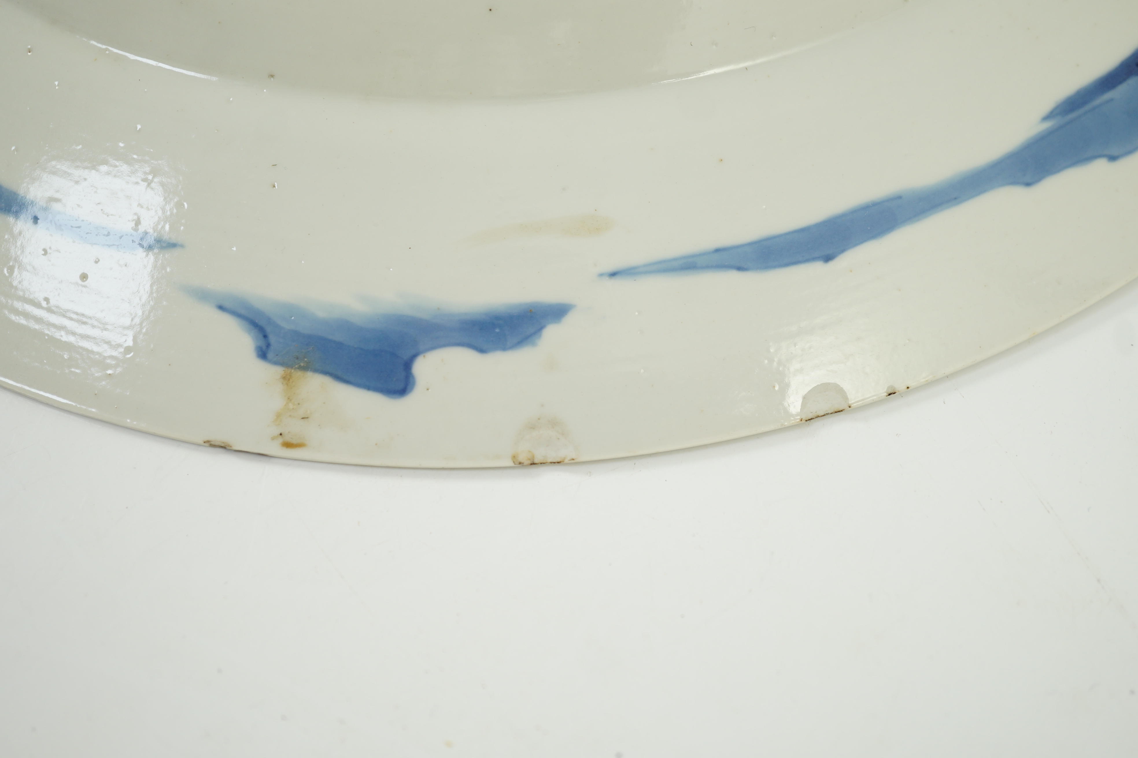 A Chinese blue and white ‘court scene’ dish, Kangxi period, two rim cracks and small splinter chips